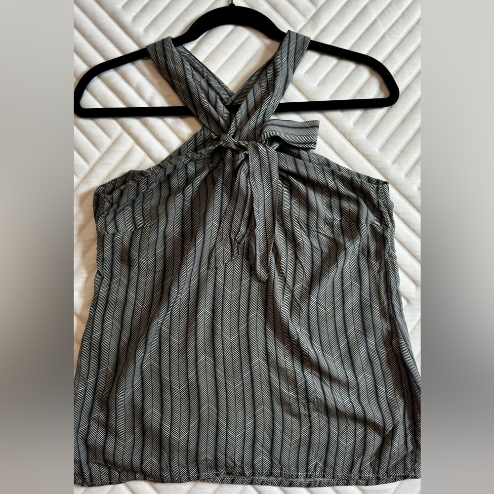Elegant blouse features a unique design in navy blue tones.